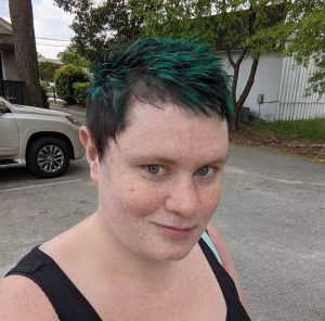 photo of a female with short black and green hair